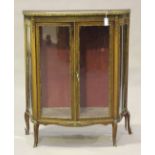 An early 20th century French Transitional style walnut and gilt metal mounted vitrine, the rouge