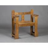 An Edwardian Arts and Crafts oak hall bench, possibly retailed by Liberty & Co, the pierced back and