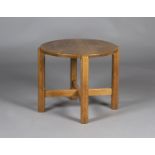 An early 20th century Arts and Crafts style oak circular occasional table, in the manner of Heals,