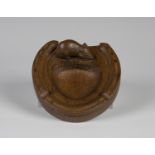 A Robert 'Mouseman' Thompson oak ashtray, carved in the form of a horseshoe, bearing typical mouse