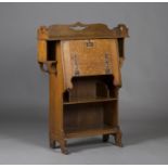 An Edwardian Arts and Crafts oak student's bureau, the pierced gallery back above a fall-flap and