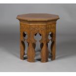 An Arts and Crafts style oak octagonal occasional table, the cavetto moulded and carved frieze above