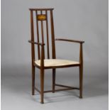 An early 20th century Arts and Crafts style mahogany elbow chair, possibly designed by Joseph