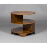 An early 20th century Heals style walnut circular book table, the two open tiers raised on stepped