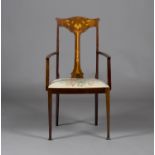 An Edwardian Arts and Crafts mahogany elbow chair, the shaped splat back inlaid with a stylized