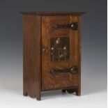 An Edwardian Arts and Crafts oak and copper mounted table top cabinet, in the manner of Shapland &