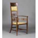 A late Victorian Arts and Crafts mahogany high back elbow chair by J.S. Henry, with boxwood line