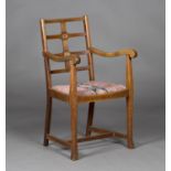 An early 20th century Arts and Crafts style oak framed elbow chair, in the manner of Heals, the