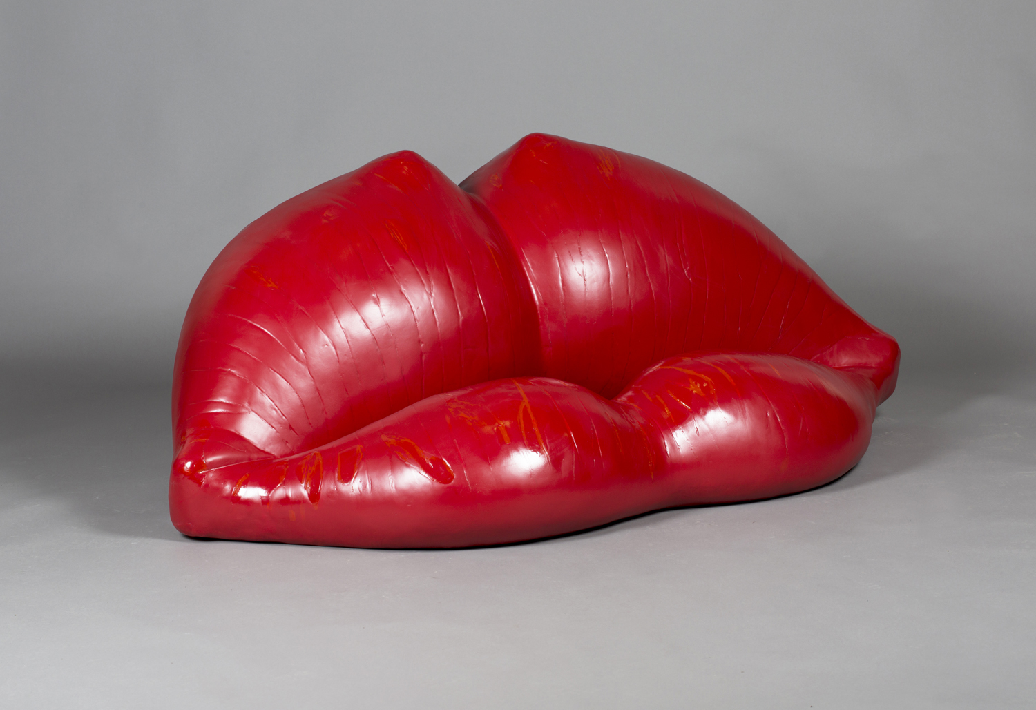 A Louis Durot red polyurethane and foam 'L'échauffeuse' sofa sculpture, moulded in the form of a