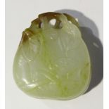 A Chinese jade pendant, probably late Qing dynasty, of gourd form, carved in low relief with lingzhi