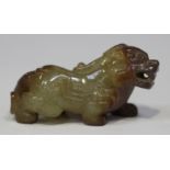 A Chinese carved jade figure of a Buddhistic lion, probably 20th century, modelled in a crouching