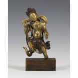 A Sino-Tibetan gilt and brown patinated bronze figure of a bodhisattva, Qing dynasty, modelled