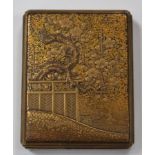 A Japanese gilt lacquer small rectangular box and cover, Meiji period, decorated with a blossoming