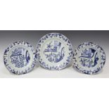 A pair of Chinese blue and white export porcelain plates and a matching larger dish, Kangxi