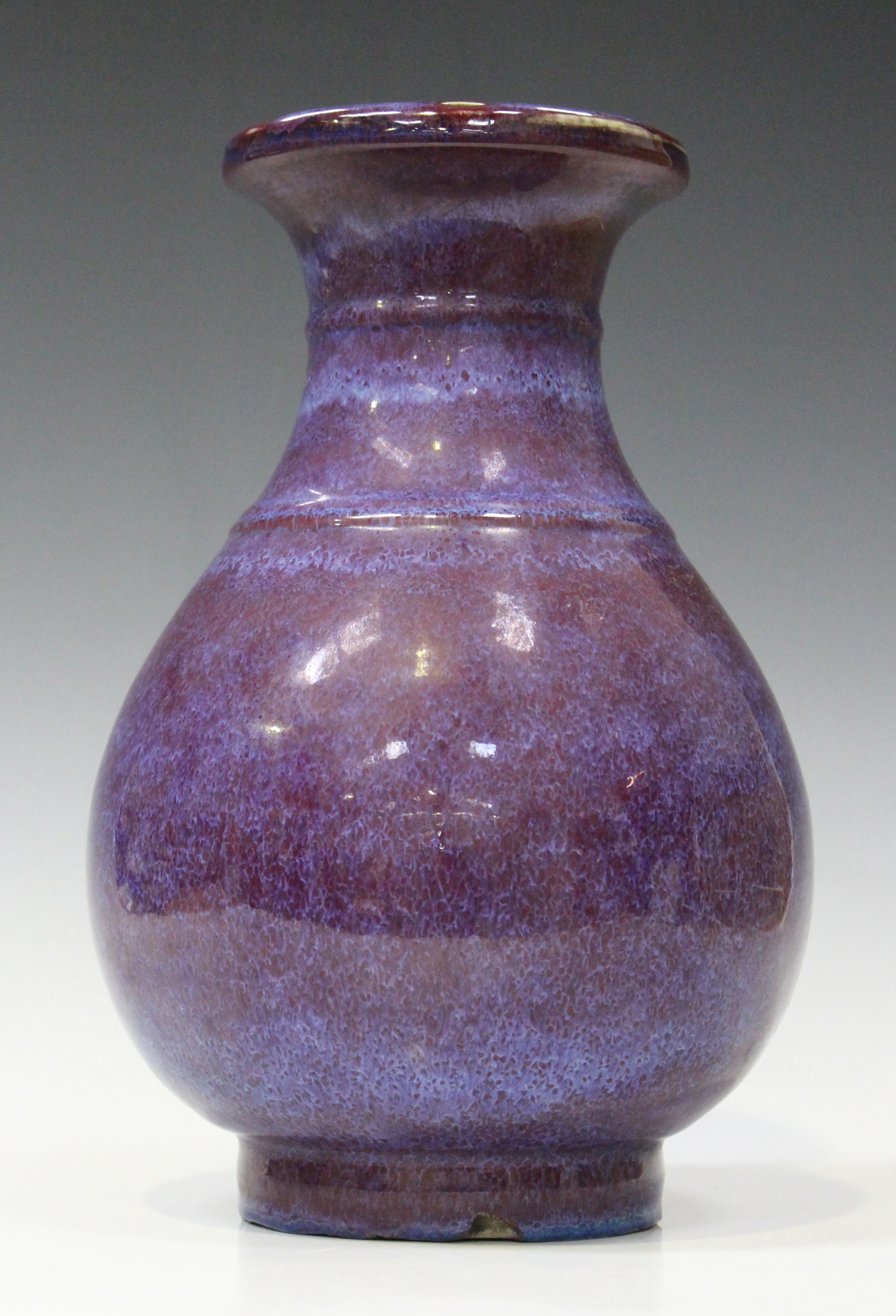 A Chinese flambé glazed porcelain vase, 20th century, the pear shaped body with pierced rim, covered