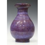 A Chinese flambé glazed porcelain vase, 20th century, the pear shaped body with pierced rim, covered