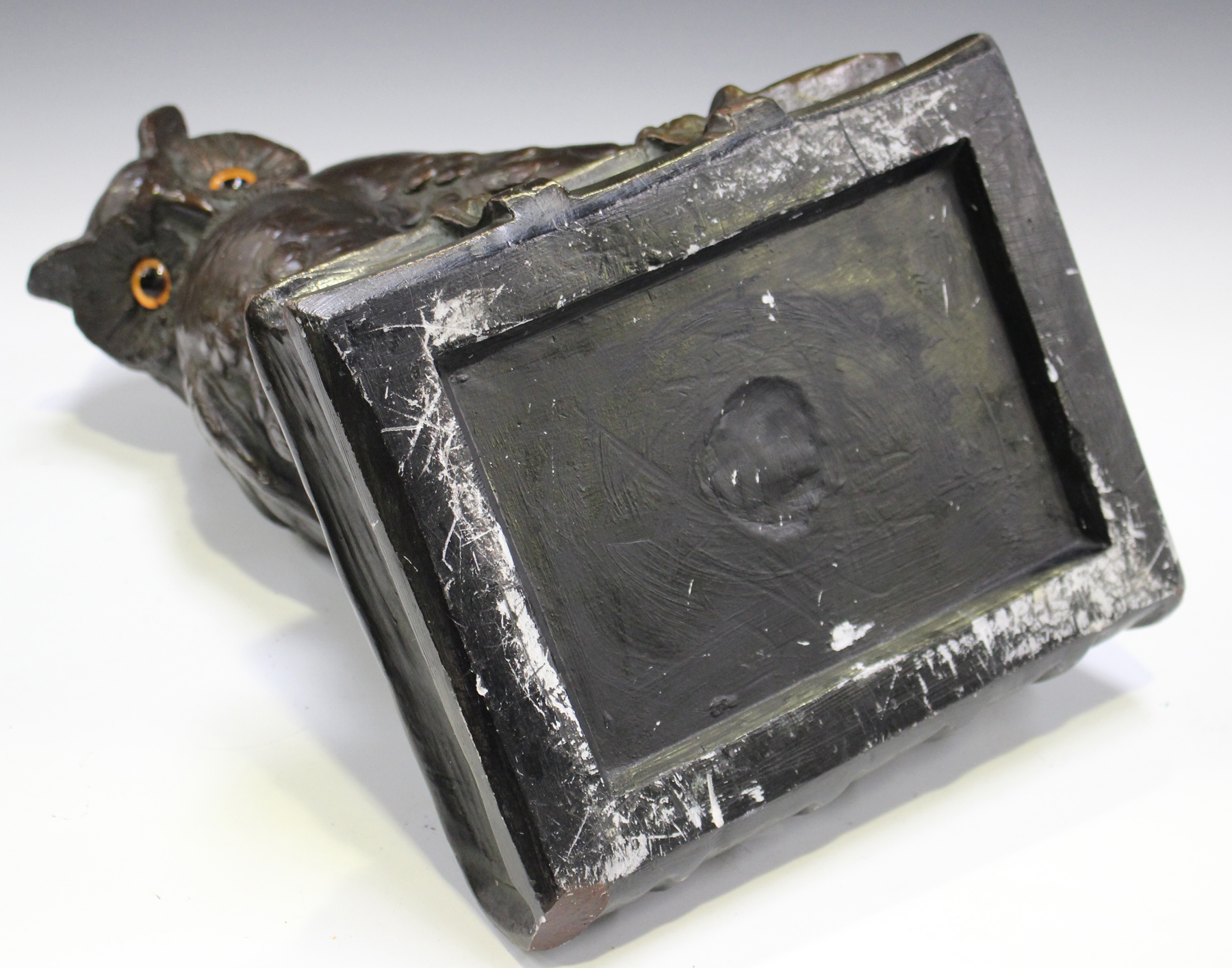 An early 20th century German bronzed cast plaster model of an owl seated on a quill and book, - Image 2 of 4