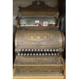 A late 19th century brass cased National counter-top cash register with overall cast rosettes and