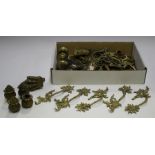 A group of 19th century brass furniture handles, a set of four cast brass claw capped castors and
