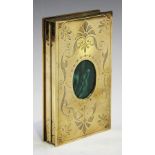 A late 19th century French cast brass folding photograph frame, the cover inset with a malachite