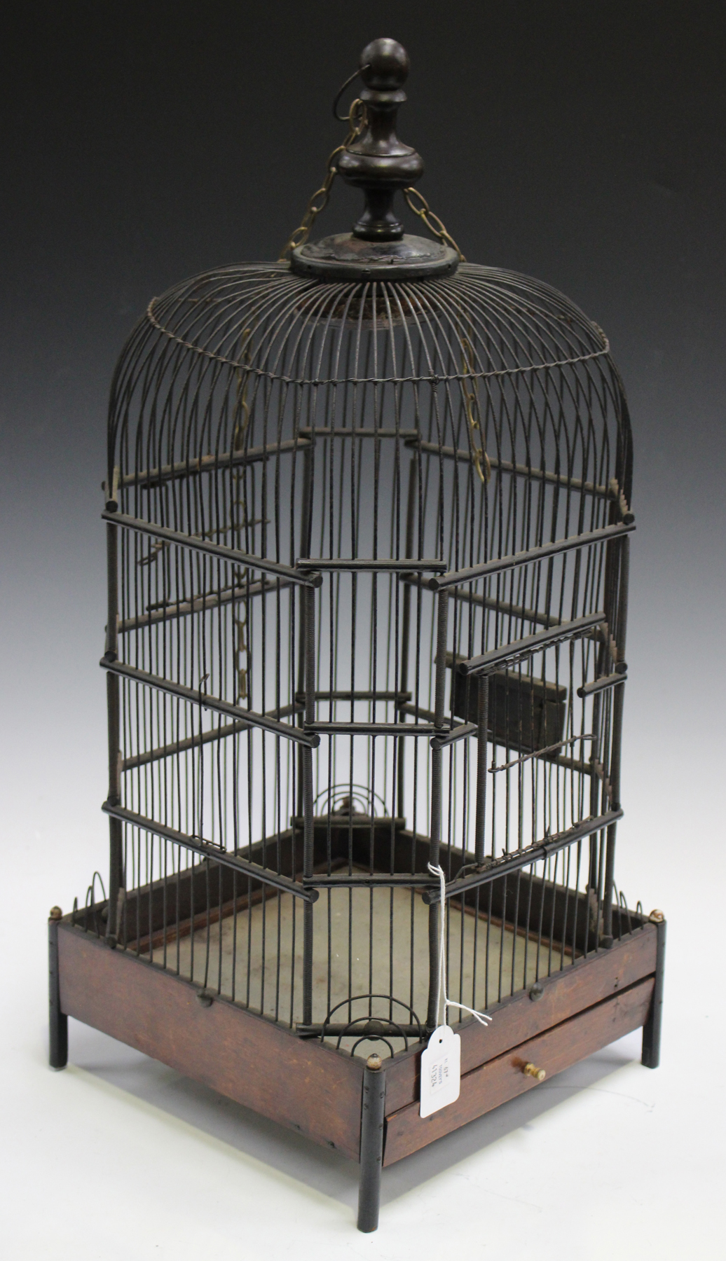 An early 20th century wirework birdcage of domed form, the base fitted with a sliding mirrored tray,