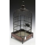 An early 20th century wirework birdcage of domed form, the base fitted with a sliding mirrored tray,