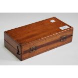 An Edwardian mahogany cased travelling chess set, fitted with turned bone playing pieces, width