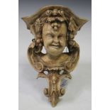 A George III carved wooden wall bracket of bacchic mask form, the reverse bearing label marked '