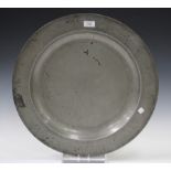 An 18th century English pewter charger, bearing London touch marks to underside, diameter 51.5cm.