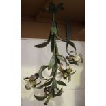 An early 20th century French tole painted wrought metal four light chandelier in the form of a