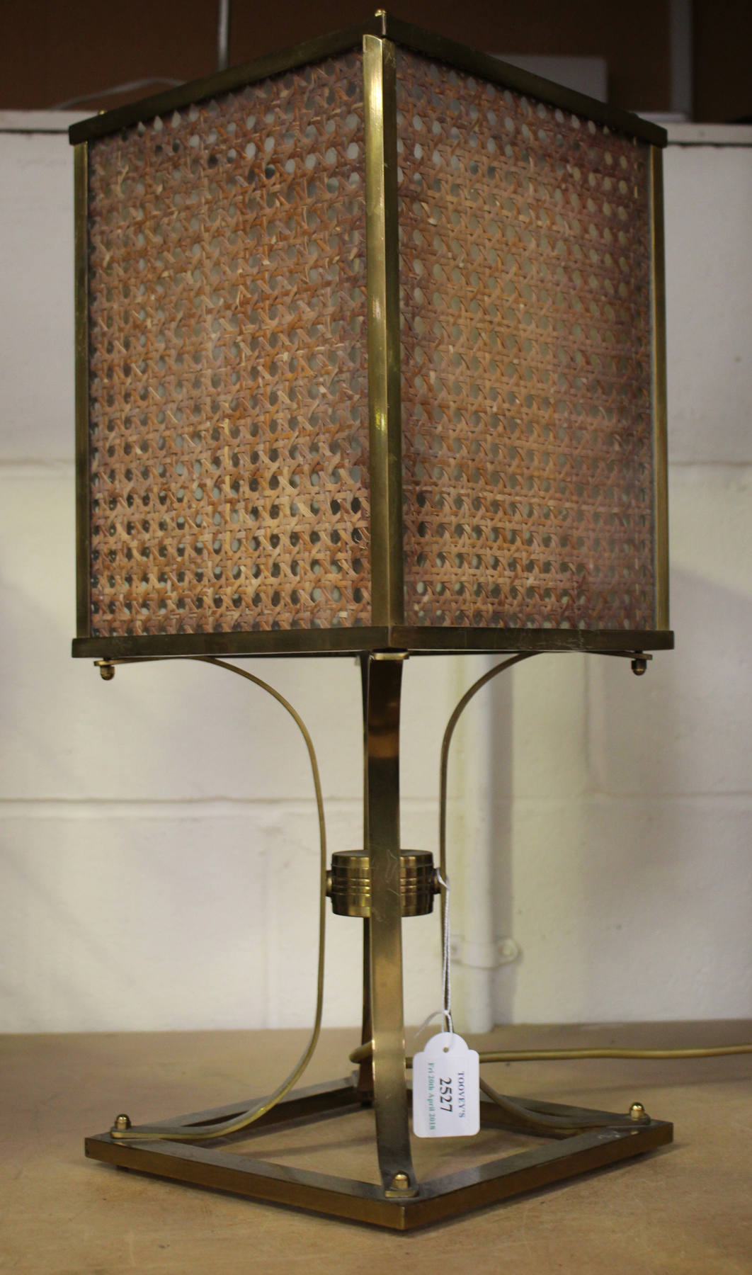 A mid-20th century brass framed table lamp, the glazed shade inset with caned panels, height 50cm.