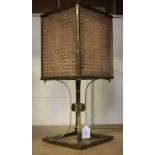 A mid-20th century brass framed table lamp, the glazed shade inset with caned panels, height 50cm.