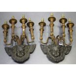A pair of late 19th century cast iron and turned wooden four light wall sconces, each backplate in