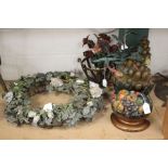 An early 20th century French tole painted wrought metal and porcelain mounted ornamental wreath of