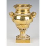 A Regency gilt bronze urn, the ogee baluster body with liner and flanked by a pair of amorini