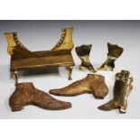 A late Victorian brass novelty footman with a pair of lady's boot surmounts, width 26cm, a pair of