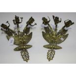 A pair of 19th century French cast brass triple light wall sconces, each in the form of an eagle