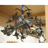 An early 20th century French tole painted wrought metal three light chandelier, worked as overall