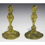 A pair of 19th century Rococo Revival cast ormolu candlesticks of foliate scrolling form, height