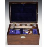 A Victorian rosewood cased vanity box, the hinged lid enclosing a compartmentalized interior
