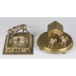 A late 19th century brass novelty inkwell in the form of two dogs in front of a kennel, the hinged