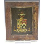An early 19th century painted and gilt panel, depicting an armorial crest, 28cm x 20cm, within a