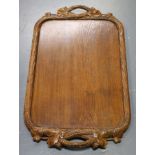 A mid-20th century Swiss Black Forest carved oak tea tray, the border naturalistically carved in the