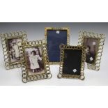 A group of five late 19th century French brass photograph frames with chainlink borders and strut