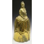 A late 19th century brass novelty fireguard, modelled in the form of a standing lady wearing a large