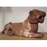 A 19th century terracotta model of a recumbent lioness, length 70cm (some surface flaking and