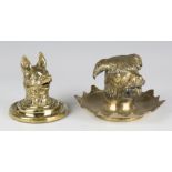 A mid-19th century cast brass novelty inkwell in the form of a dog's head, the hinged top