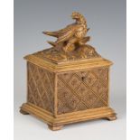 A late 19th/early 20th century Swiss Black Forest carved softwood tea caddy, the hinged lid modelled