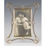 A late Victorian brass photograph frame of twisted chainlink design, 32.5cm x 26cm. Provenance: from