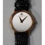 A Baume & Mercier gold circular cased lady's wristwatch, the signed brushed silvered dial with